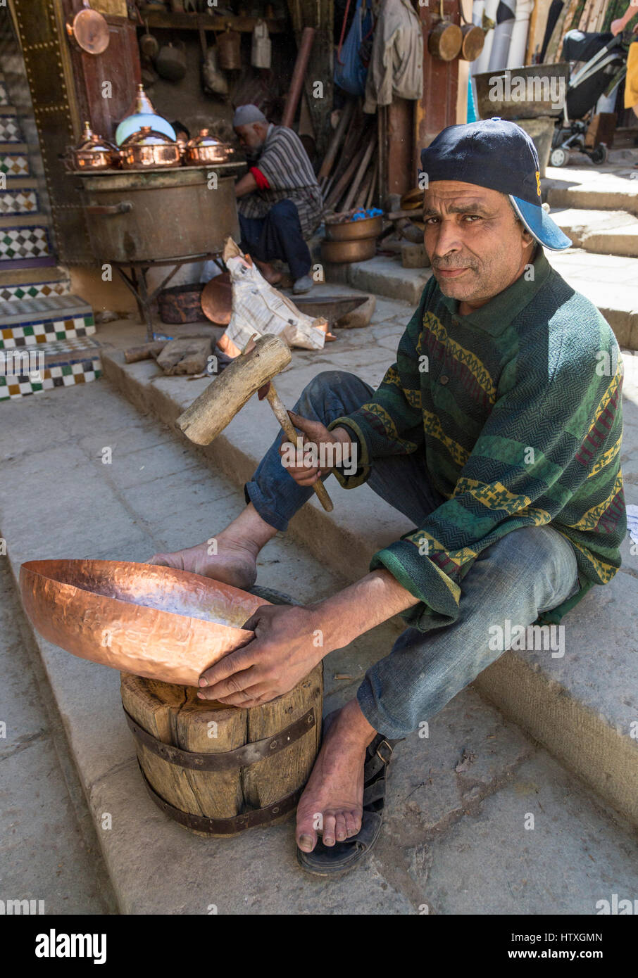 Fes, Marocco. Posizionare Seffarine. Martellatura artigiano un recipiente di rame in forma. Foto Stock