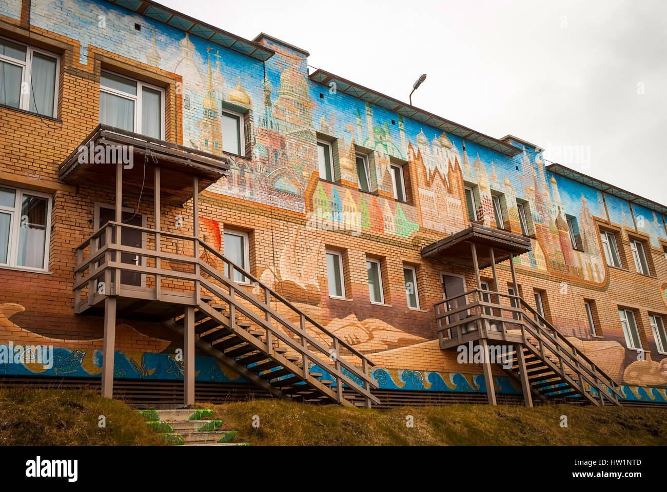 BARENTSBURG, Norvegia - 21 giugno: painitings colorati con norvegese e motivi russo addolorato sulla facciata della scuola a Barentsburg scuola su Giugno 21, 2015 Foto Stock