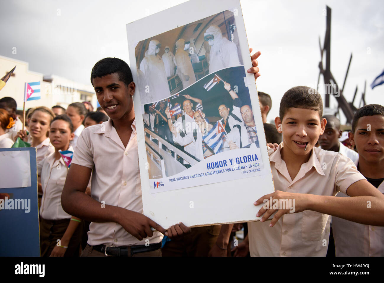 Scuola cubana bambini che portano cartelloni rivoluzionario durante il giorno di maggio celebrazioni a Santiago de Cuba, Cuba. Foto Stock