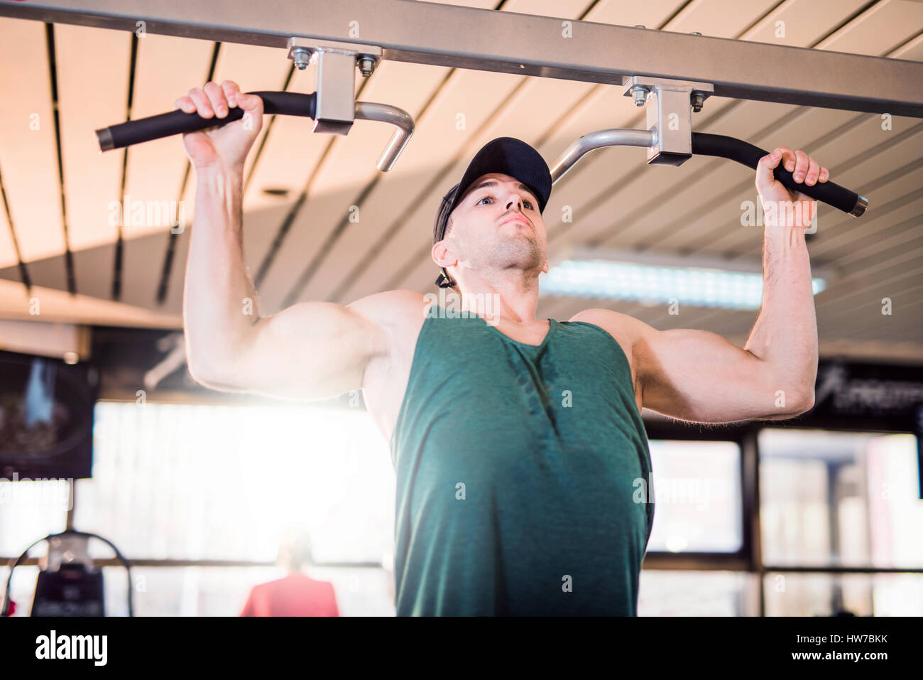 Giovane uomo facendo pull-up nel club salute Foto Stock