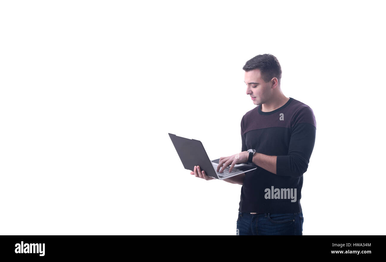 Giovane imprenditore sorridente digitando su un laptop moderno sfondo bianco Foto Stock
