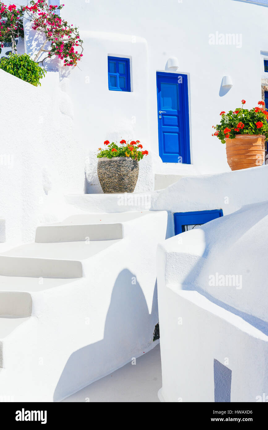 Cicladico tradizionale architettura dipinta di bianco con porte blu e vasi di fiori, imerovigli - Santorini Island, Grecia Foto Stock