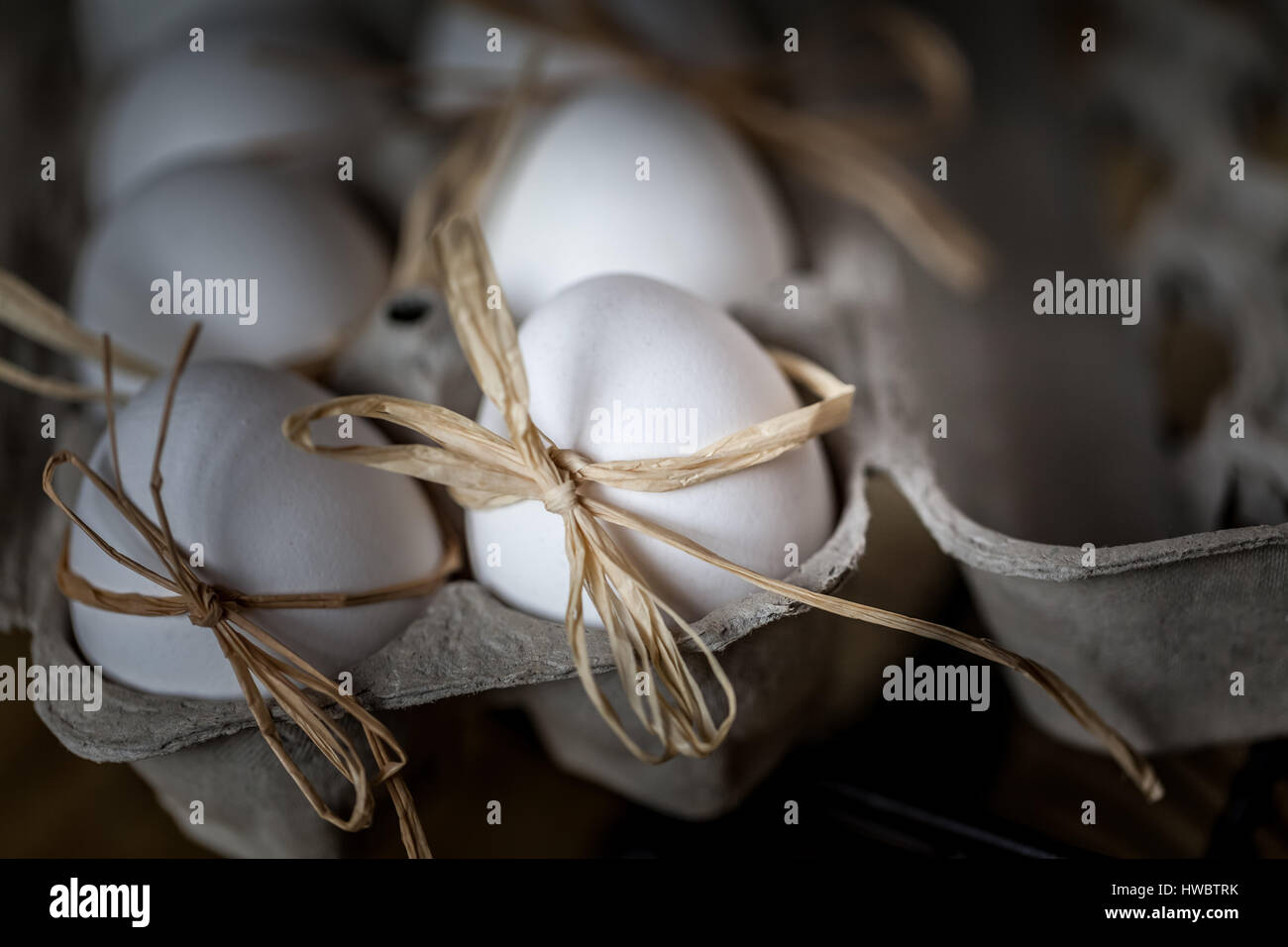 Bianco uova fresche legata con una stringa su un sfondo di legno ,il fuoco selettivo immagine concetto di pasqua Foto Stock