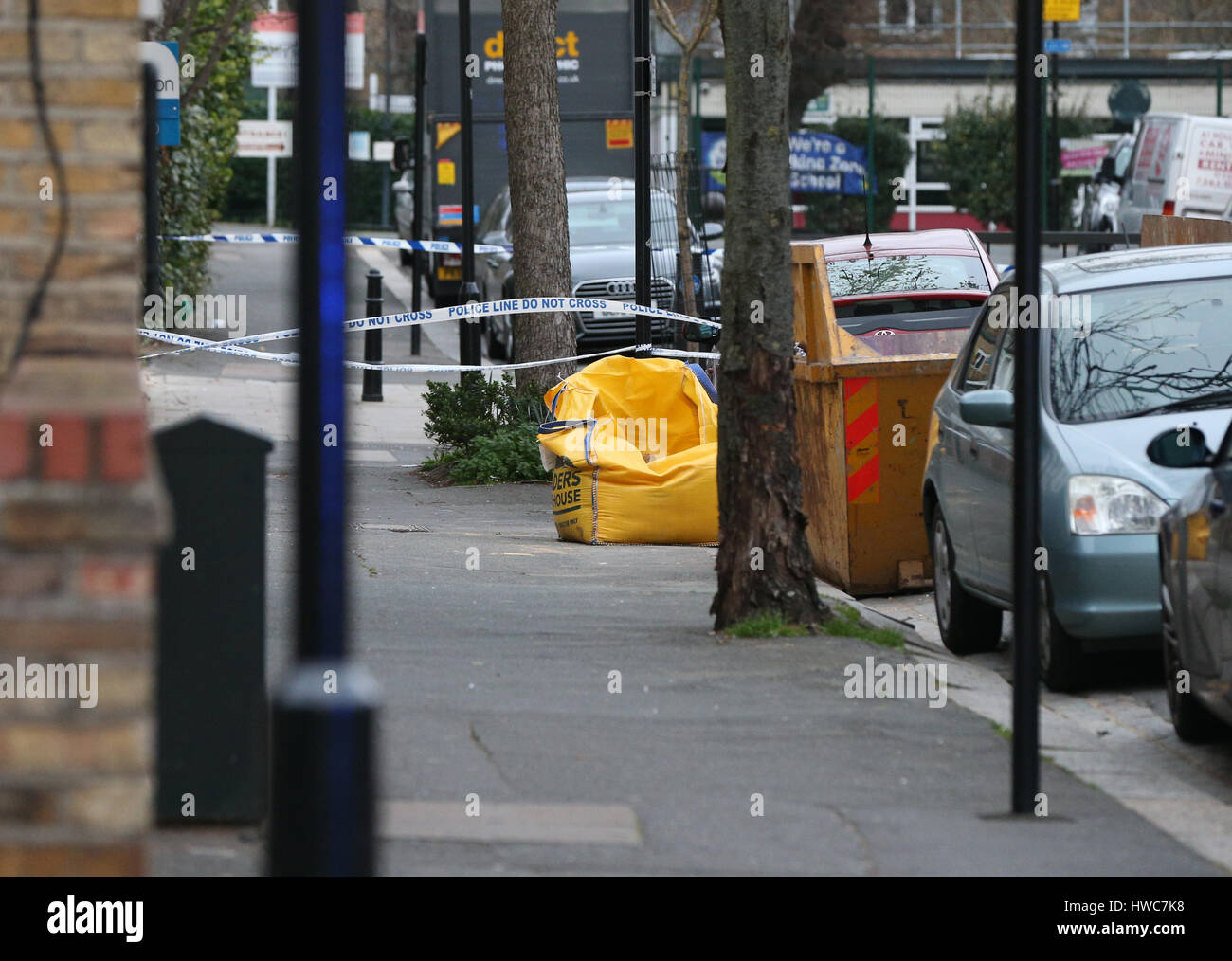 Nastro di polizia intorno un sacco di colore giallo che contiene sabbia nelle vicinanze di Somerfield Road vicino a Wilberforce Road, vicino a Finsbury Park, a nord di Londra dopo un uno-anno-vecchio ragazzo morto e una ragazza della stessa età è stato lasciato in una condizione critica in un piatto. Foto Stock