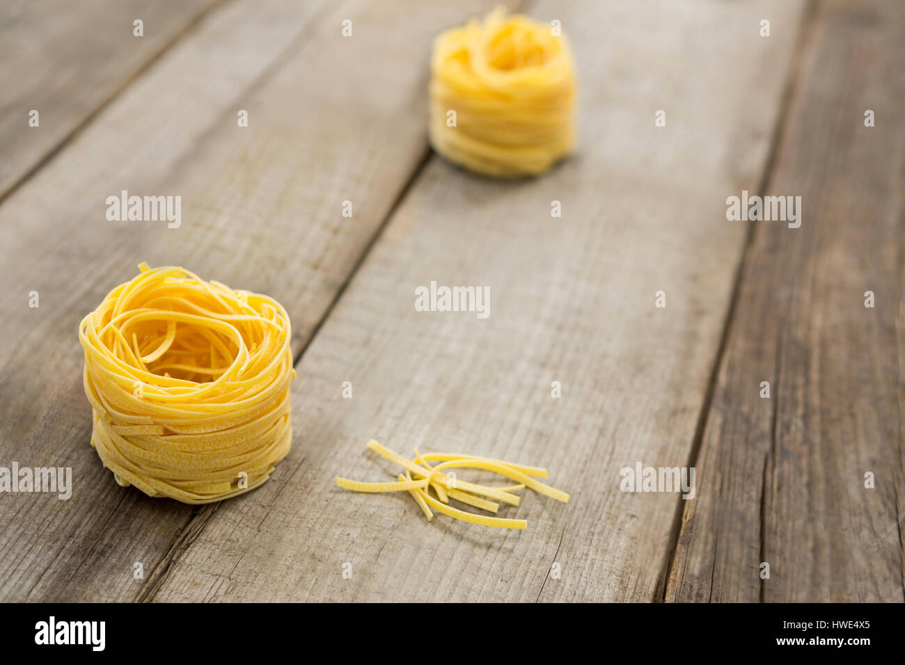 Rotolo di tagliatelle su una superficie di legno Foto Stock