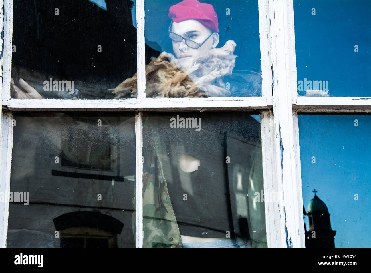 Un grungy manichino nella finestra di una corsa verso il basso edificio. La moda dei ribelli nel cuore di Inghilterra rurale. Foto Stock
