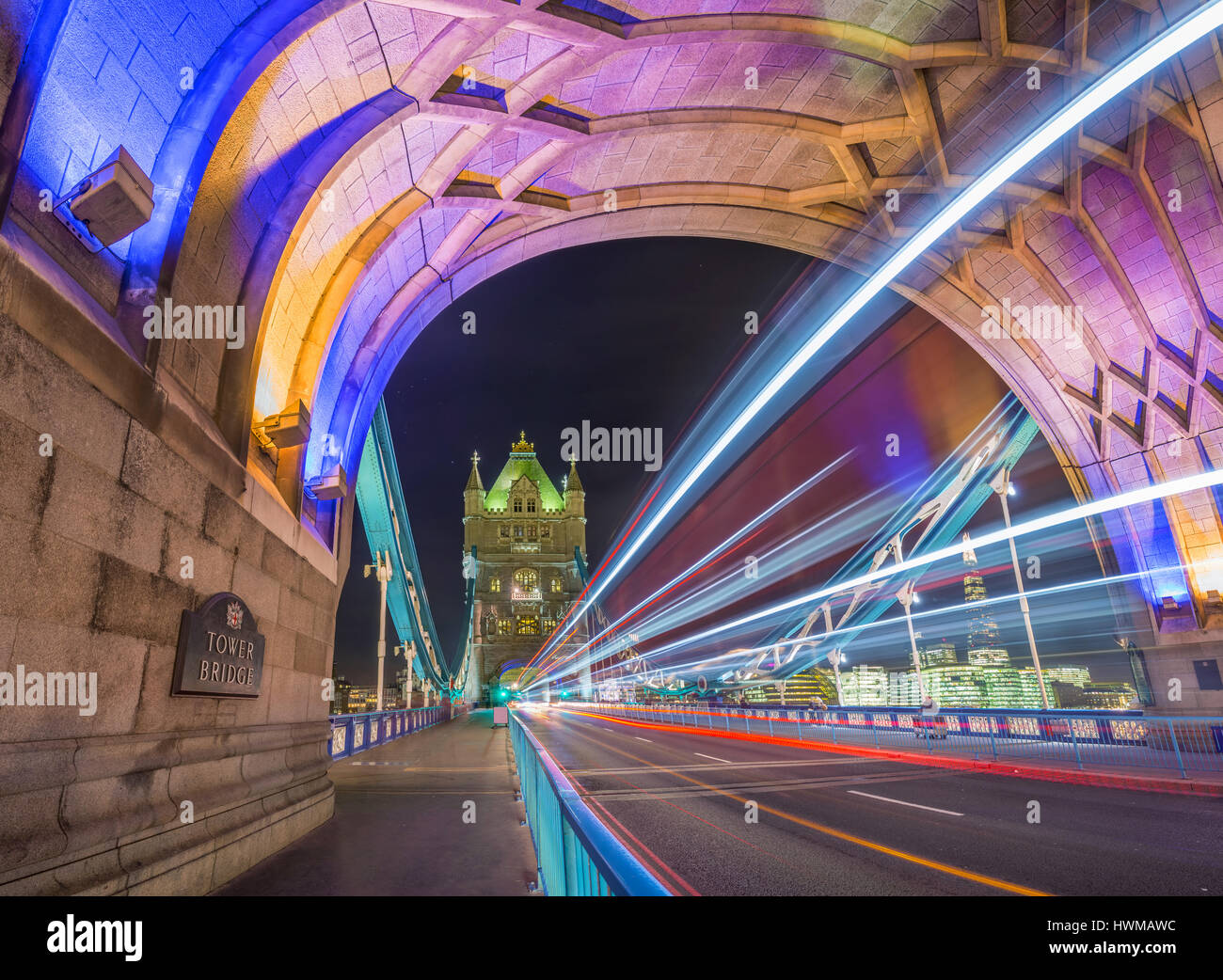 Londra, Inghilterra - Night Shot della famosa in tutto il mondo colorato il Tower Bridge di Londra con double decker bus sentieri di luce e di uffici e di Shard grattacielo Foto Stock