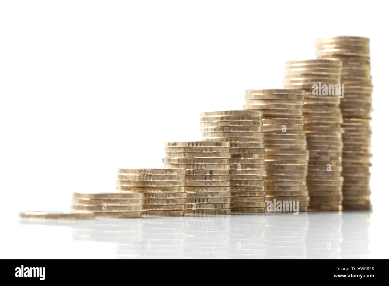 Aumentare le dimensioni delle pile di monete impilate disposte come schema ascendente, che simbolizza la crescita isolato su bianco. Foto Stock