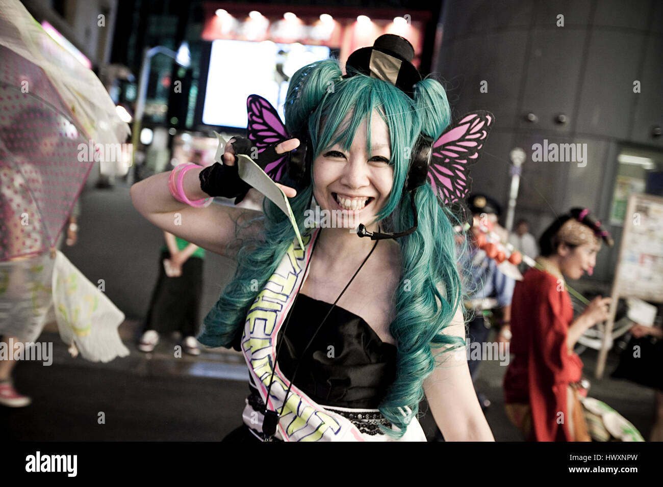 Un felice cosplayer giapponese che dà il segno di pace a Tokyo in Giappone. Questa ragazza giapponese è un cosplay di Hatsune Miku. Cosplay è una performance art di rep Foto Stock