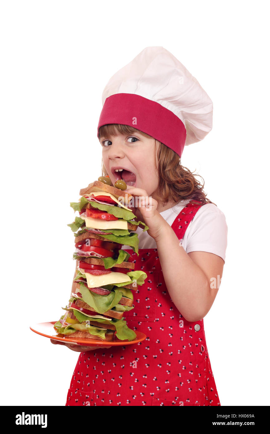 Fame bambina cucinare mangiare panino di grandi dimensioni Foto Stock