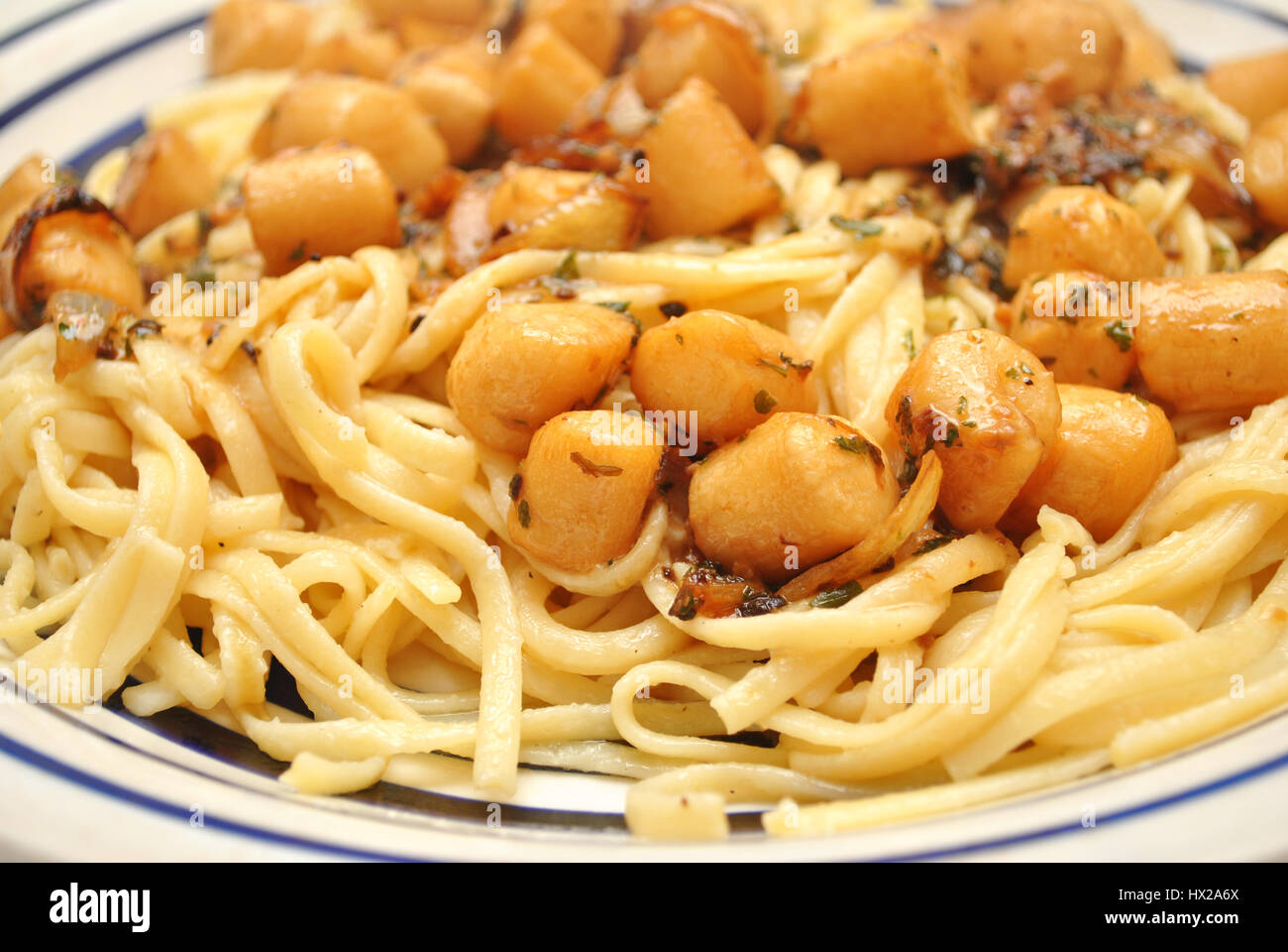 Servita Linguini con capesante e salsa di aglio Foto Stock