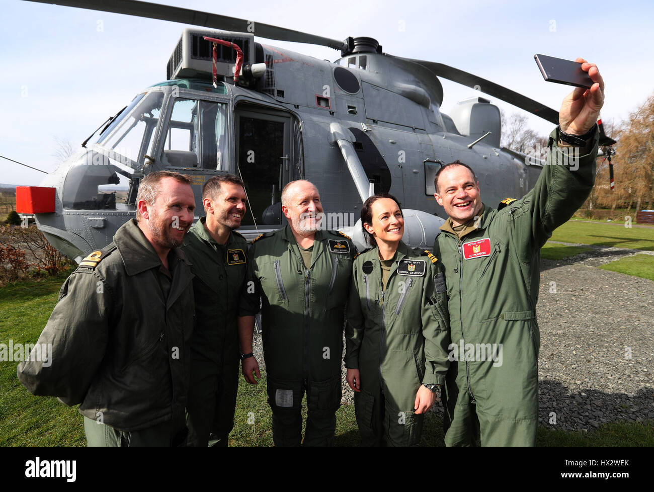 Lt Cdr Andy Murray (centro, che ha volato il convertito elicottero molte volte quando era in servizio attivo a RNAS Culdrose) ha un selfie presi con il suo equipaggio durante una visita a vedere ex Navy elicottero presso la sua nuova base a Mains Farm Wigwams in Thornhill. Foto Stock