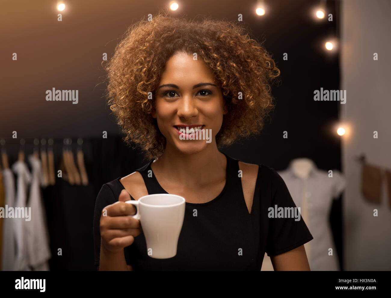 I giovani designer di moda sul suo atelier facendo una pausa e di bere il caffè Foto Stock