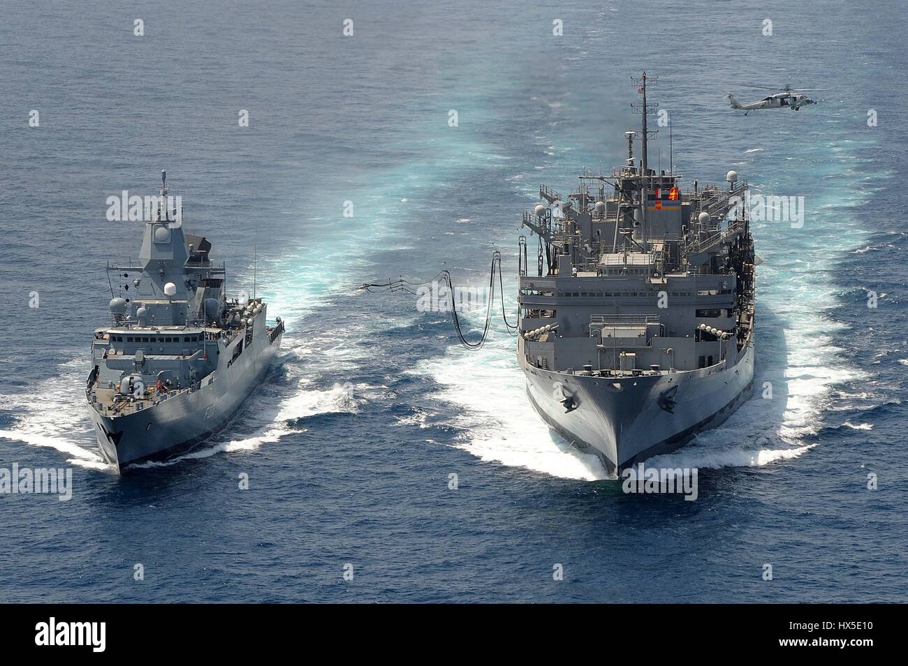 La marina militare tedesca frigate FGS Hamburd (F220) e i militari di comando Sealift fast combattere la nave appoggio USNS Ponte (T-AOE 10) durante un rifornimento in mare, mare Arabico, Marzo 23, 2013. Immagine cortesia Ryan D. McLearnon/US Navy. Foto Stock