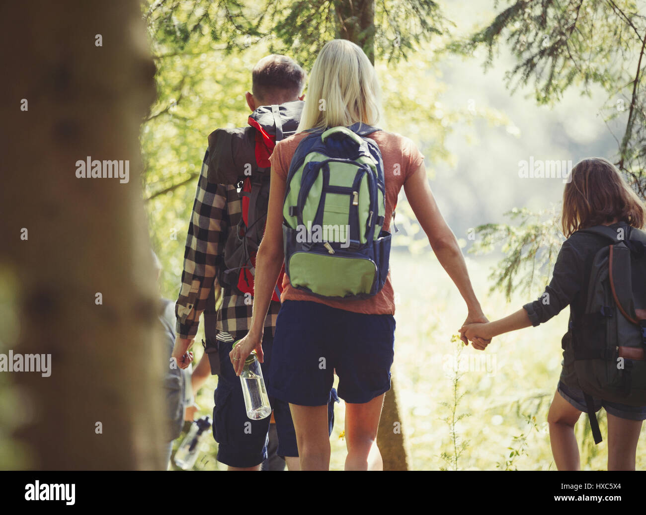 Madre e figlia con zaini holding hands escursioni nei boschi Foto Stock