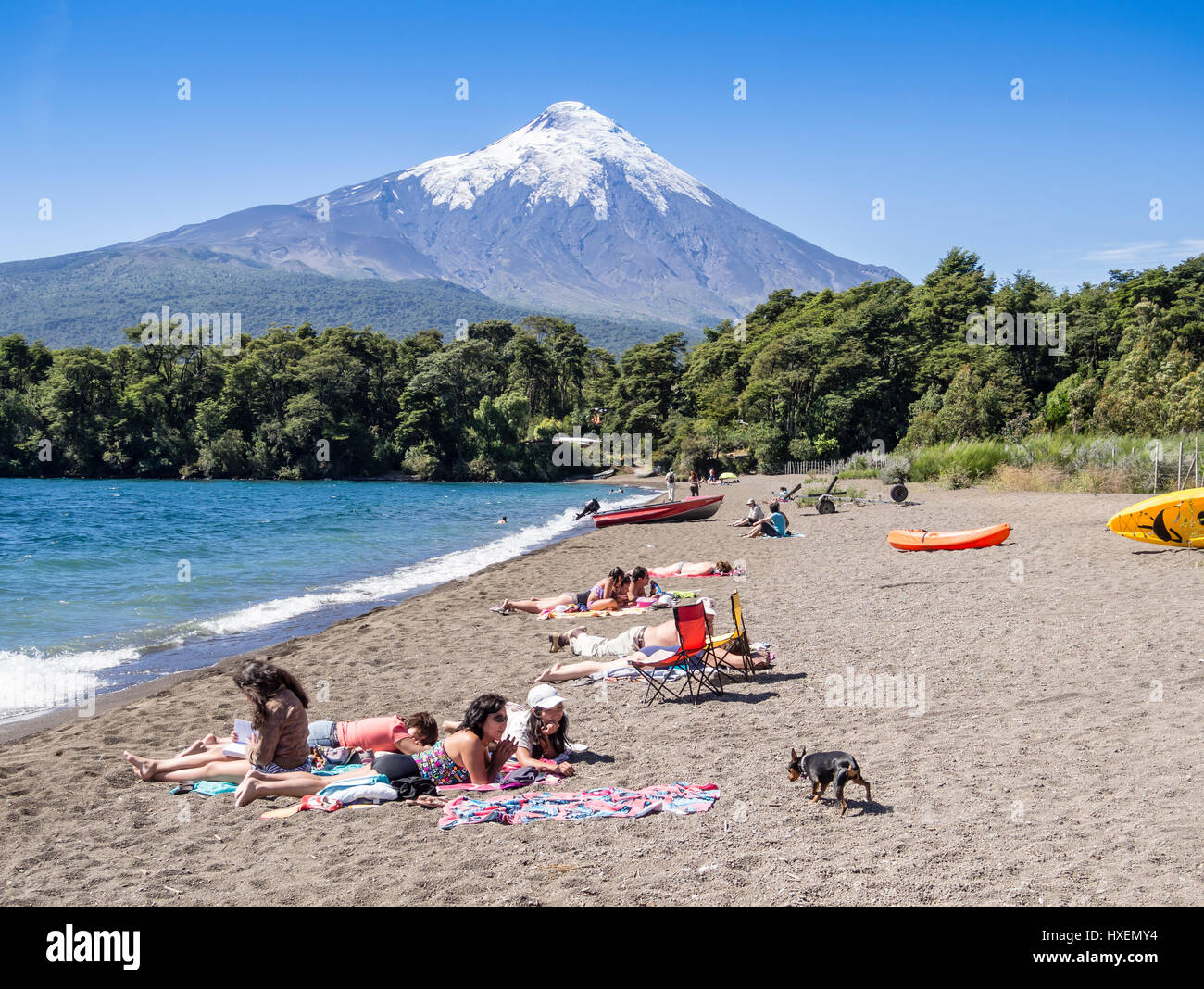 Spiaggia nel villaggio di Ensenada, lago Llanquihue, vista verso snowcovered vulcano Osorno, estate, gente sulla spiaggia a prendere il sole, nuotare, Kay Foto Stock