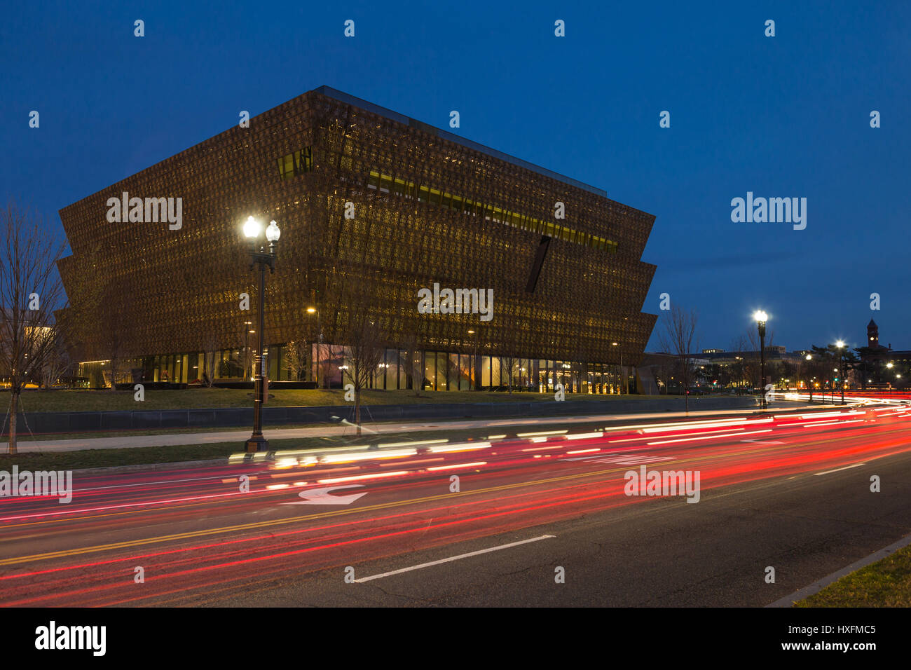 Il traffico crea percorsi di luce al crepuscolo al di fuori lo Smithsonian National Museum of African American Storia e cultura (NMAAHC) in Washington, DC. Foto Stock