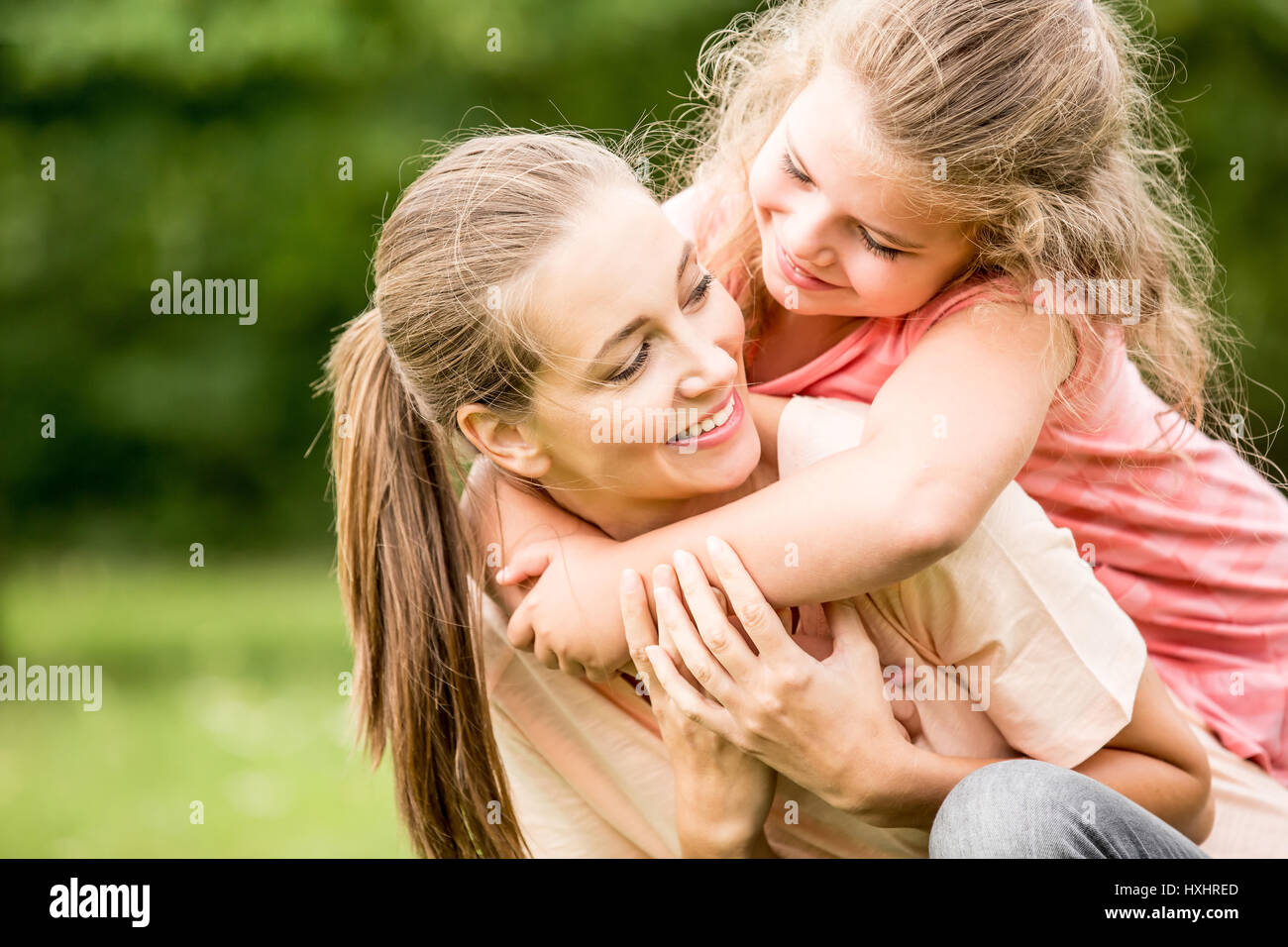 Felice madre abbracciato con amore dalla figlia Foto Stock