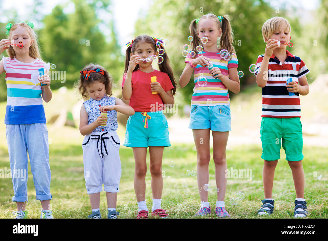 I bambini a soffiare bolle Foto Stock