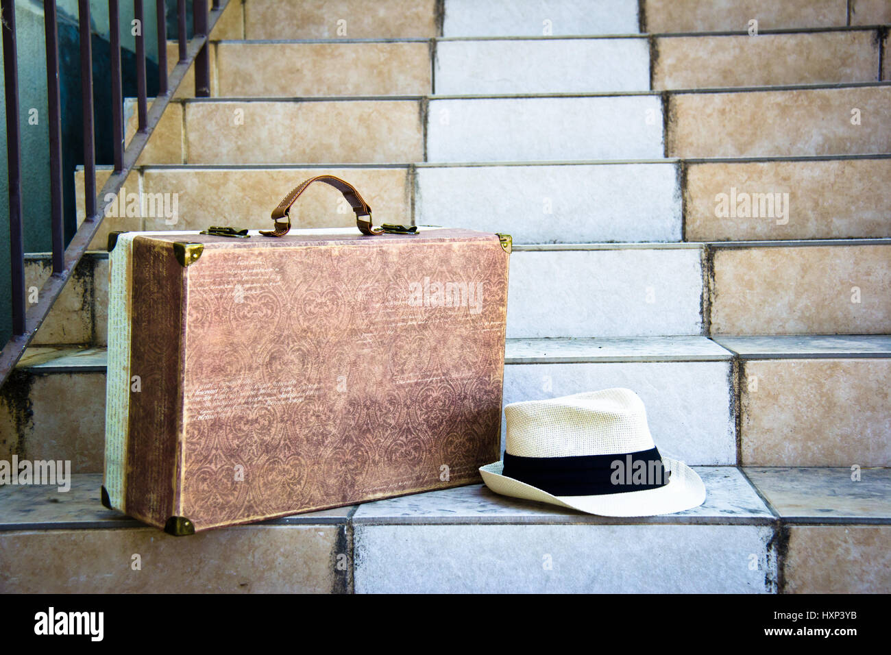 Fodor hat e bagagli seduto su una scalinata pronto per andare Foto Stock