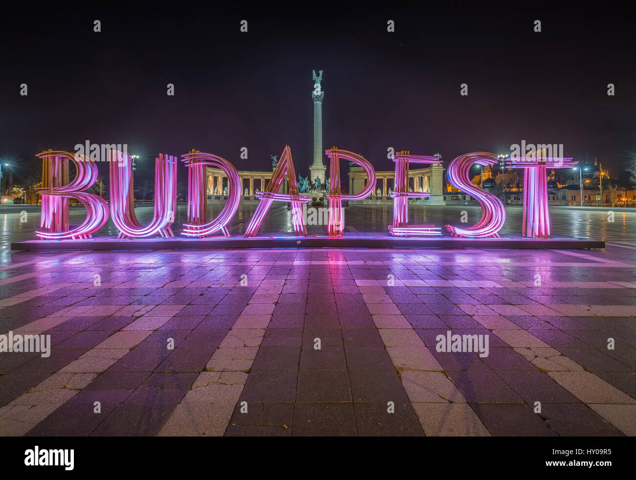Budapest, Ungheria - la bella Piazza degli Eroi, Hosok tere o il Monumento del Millennio con il segno di Budapest rosa / viola di notte Foto Stock