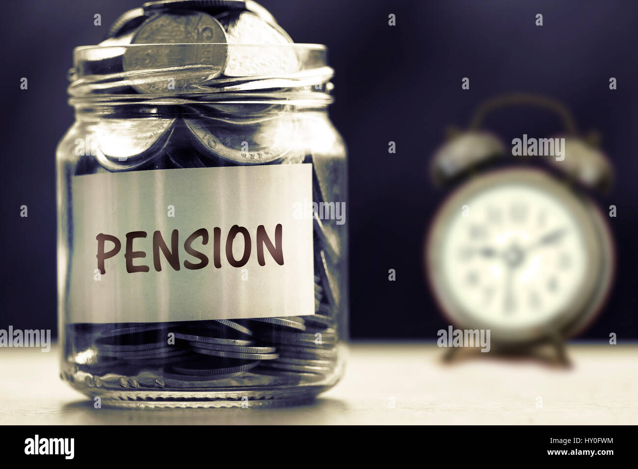 Chiudere fino alle monete in un barattolo di vetro per dare e il concetto di pensione , scuro retrò del tono di colore Foto Stock