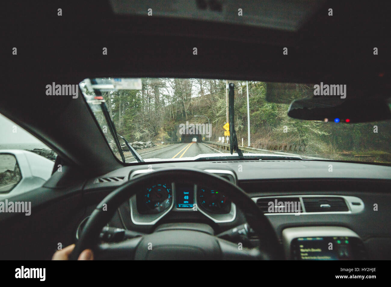 Conducente del punto di vista dall'interno auto, avvicinando un tunnel autostradale in western Oregon, Stati Uniti d'America. Foto Stock