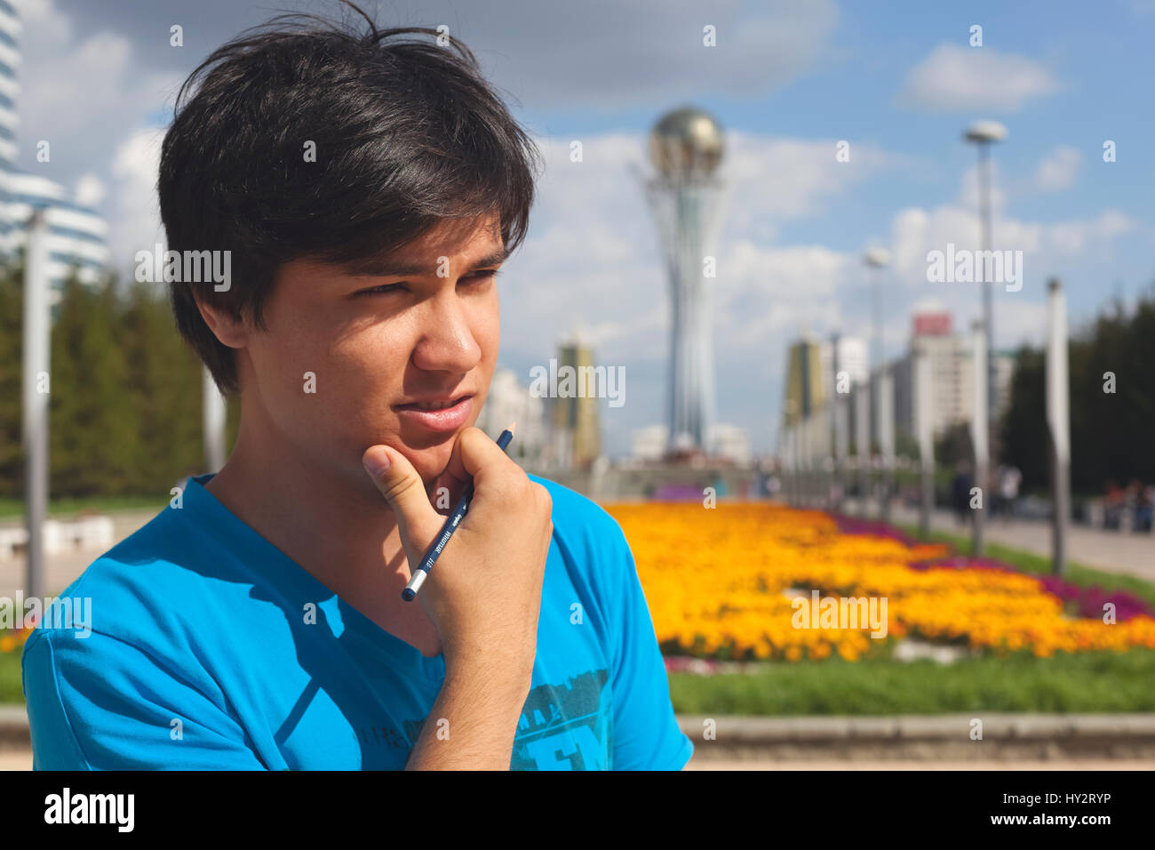 Uomo in maglietta blu sullo sfondo di Bayterek Astana, Repubblica del Kazakistan Foto Stock