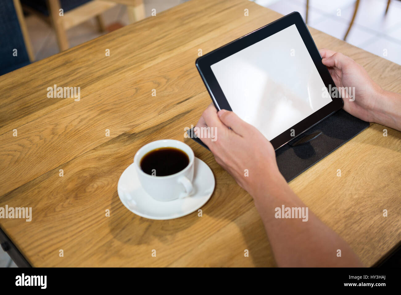 Immagine ritagliata dell uomo con tavoletta digitale con schermo vuoto in cafe Foto Stock