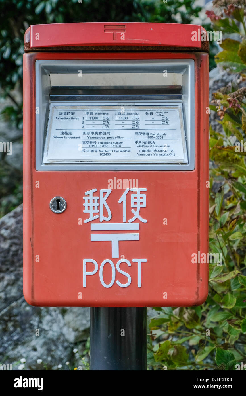 Red post box con la lingua giapponese e la lingua inglese scritta a Yamagata, Giappone Foto Stock