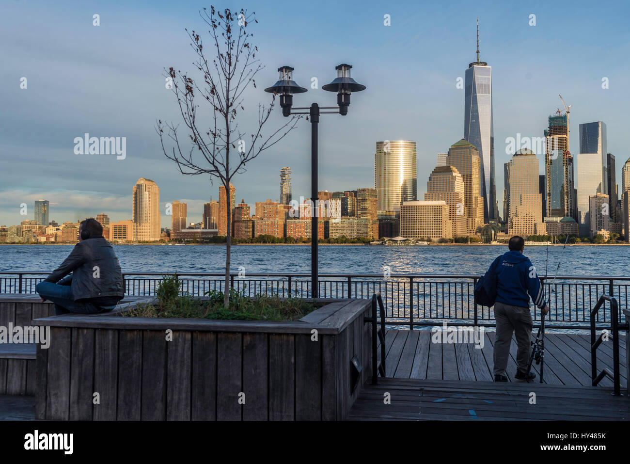 Jersey City, NJ 26 ottobre 2016 = Persone in Jersey City lungomare con una vista della parte inferiore della Skyline di Manhattan con il World Trade Center e il viscosimetro Brookfield Plaza Foto Stock