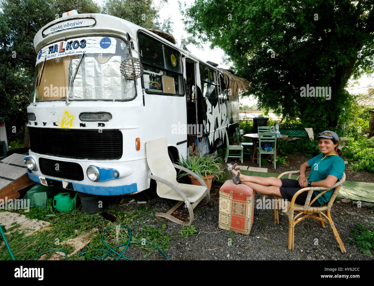 Backpacker Justine è di stare in un vecchio autobus in Paphos, Cipro. Il bus è stato fornito come un alloggio gratuito da un giovane cipriota al lettino surfers. Foto Stock