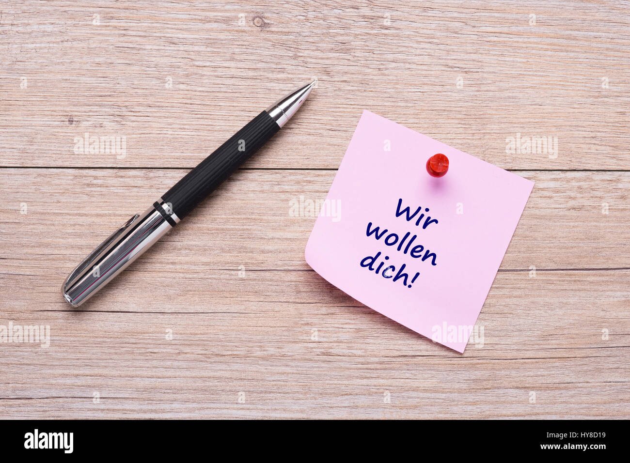 Wir wollen dich parole tedesche per vi vogliamo in rosa nota adesiva Foto Stock