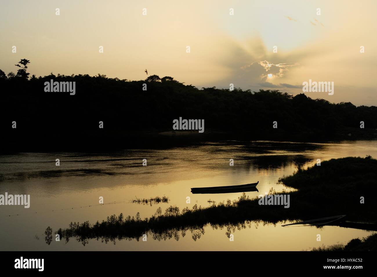 Sun impostazione sulla rete da pesca e barche sul Fiume Sewa Sumbuya vicino villaggio nel sud della Sierra Leone Foto Stock