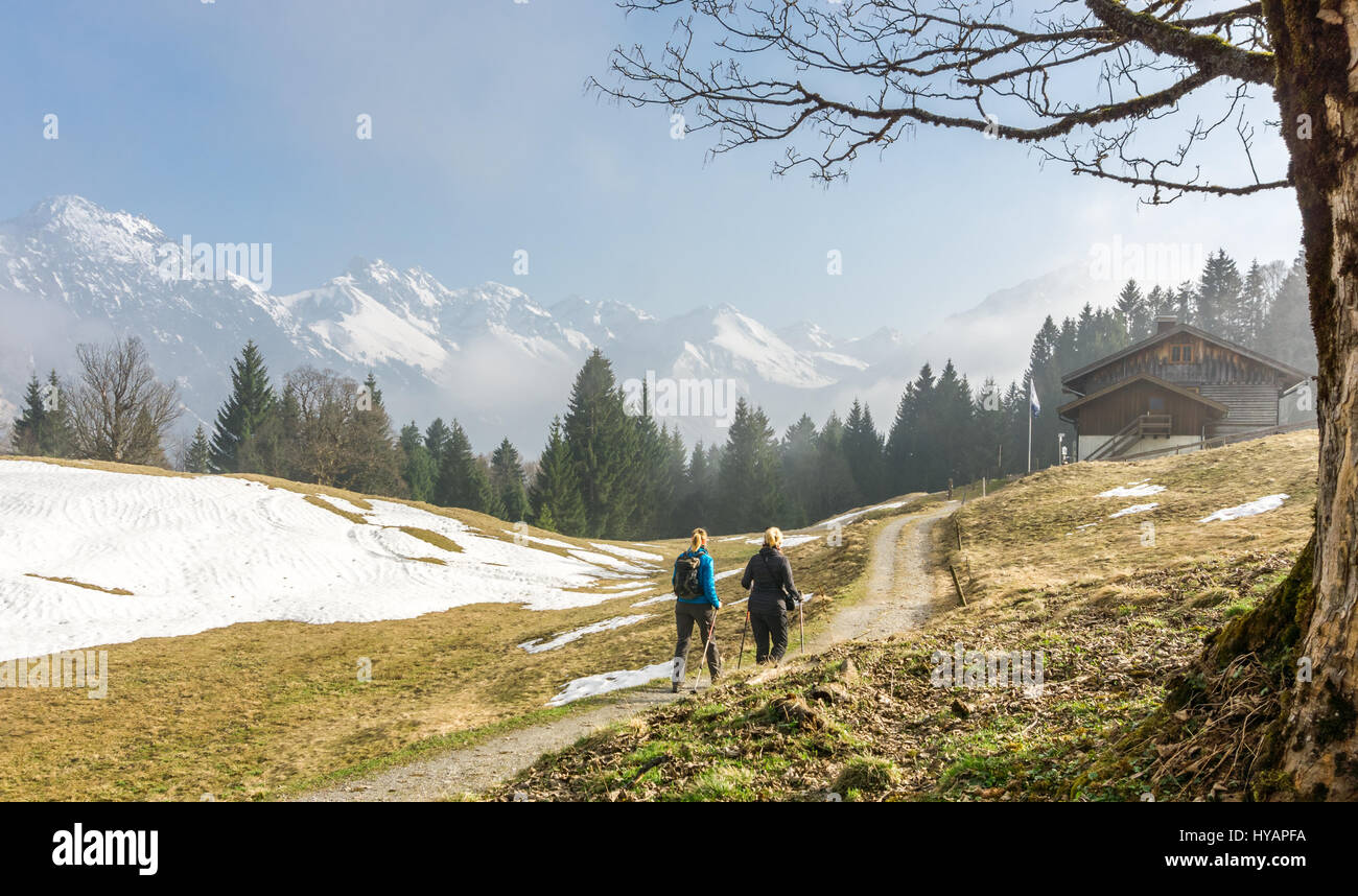 Due donne felice escursionismo insieme in montagna. raggiungendo il rifugio di montagna. Foto Stock