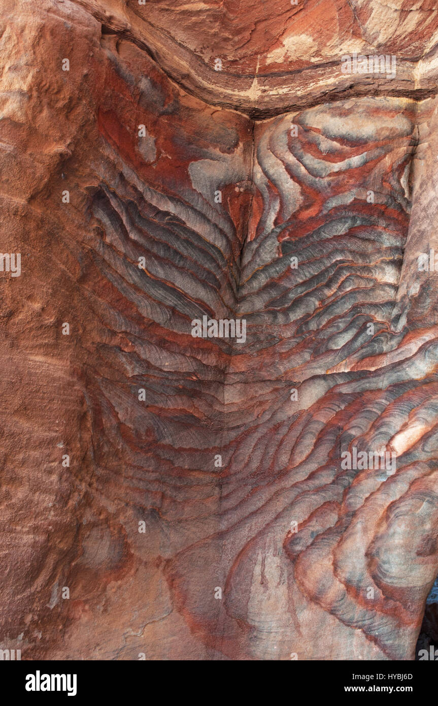 Vene di diverse forme, colori e sfumature su rocce rosse di tombe reali, strutture funerario scavato nella roccia nella città di Petra Foto Stock