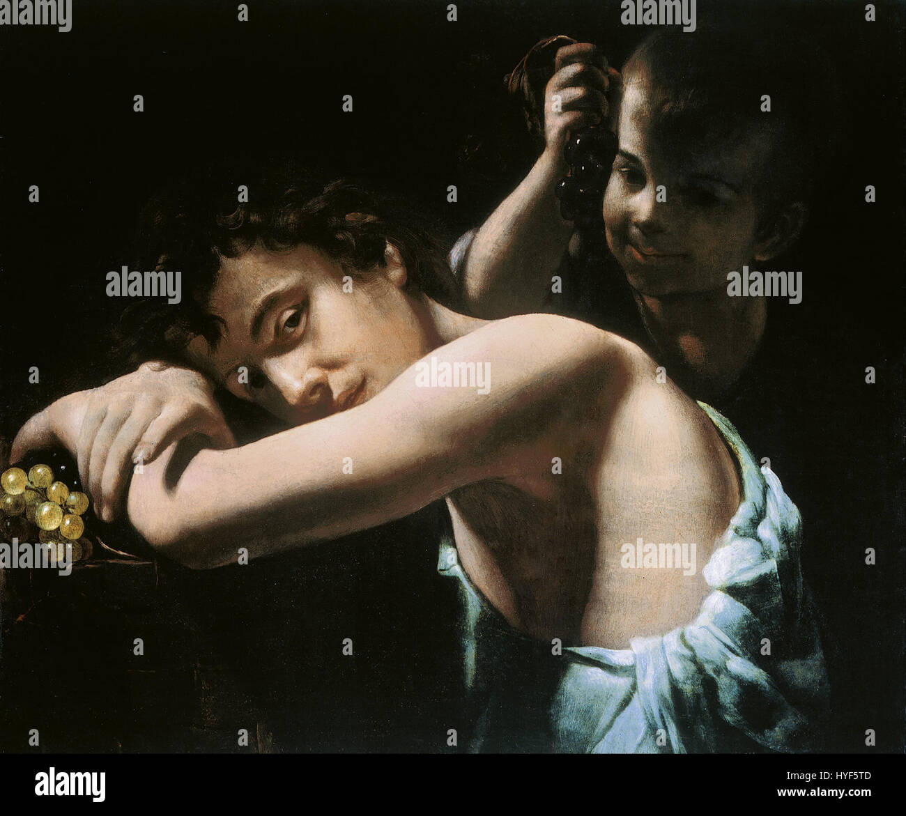 Giovanni Battista Caracciolo, noto anche come Battistello, realizzò questo dipinto raffigurante due giovani che detengono l'uva. La composizione evidenzia l'uso di luce e ombra da parte dell'artista barocco per esaltare il realistico ritratto delle figure e la loro interazione con la natura, tipico dello stile barocco italiano. Foto Stock