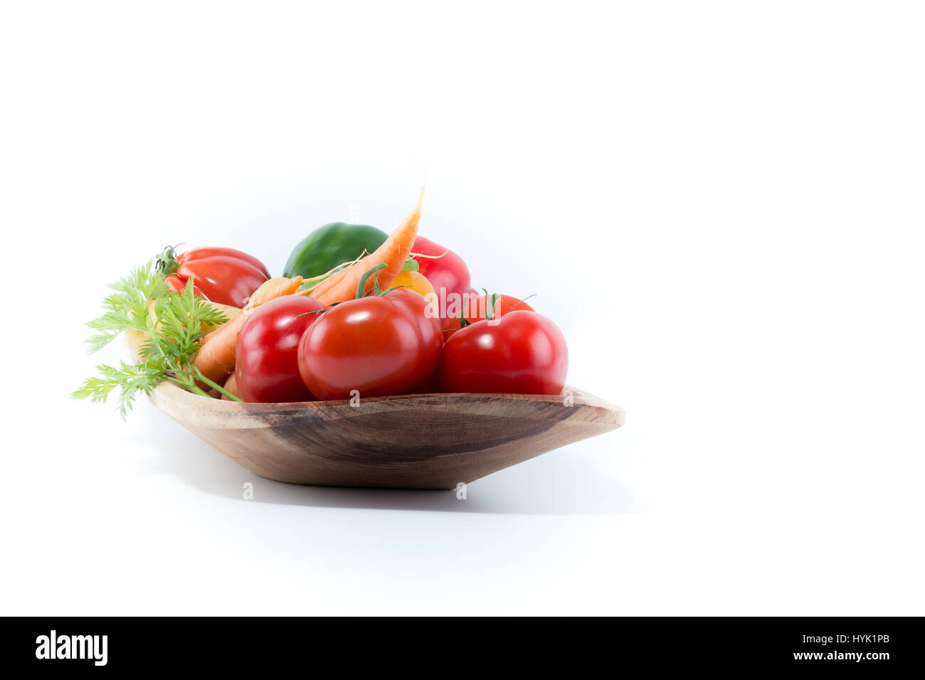 Verdure fresche in un handmade reale naturale di legno rettangolare bowl - Pomodori, carote, pepe, di fecola di patate Foto Stock