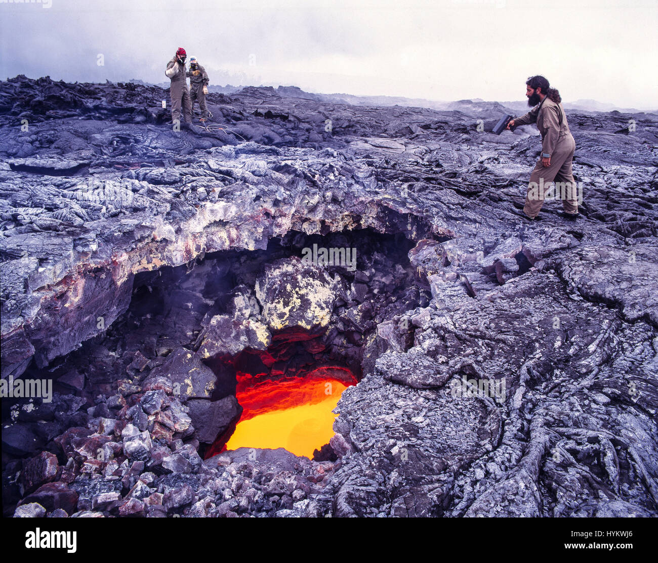 Esclusiva di Big Island delle Hawaii,: gli scienziati si prepara ad  affrontare il campione di lava dal fiume di lava entro il tubo di lava.  Scienziato sulla destra la misurazione della velocità