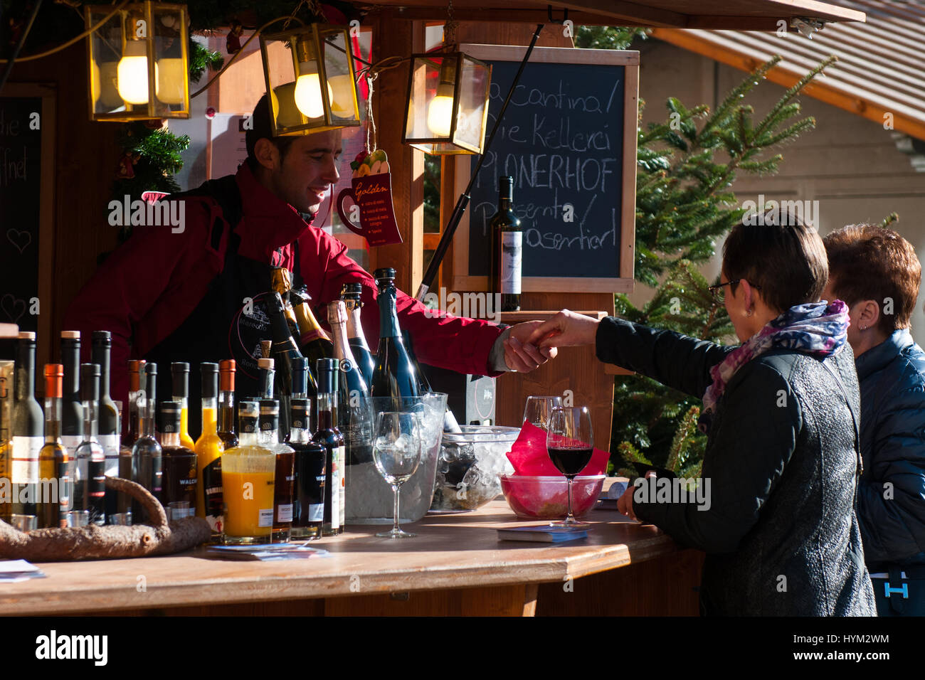 Visitatori comprare vino presso i tradizionali mercatini di Natale di Bolzano, in Italia. Foto Stock