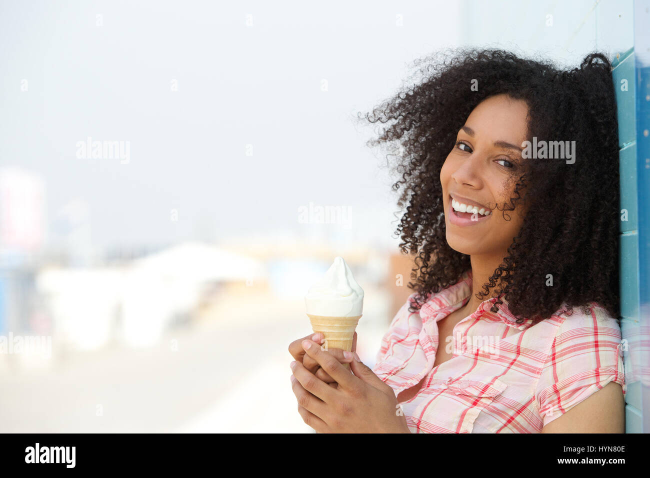 Close up ritratto di un sorridente giovane donna con cono gelato all'aperto Foto Stock