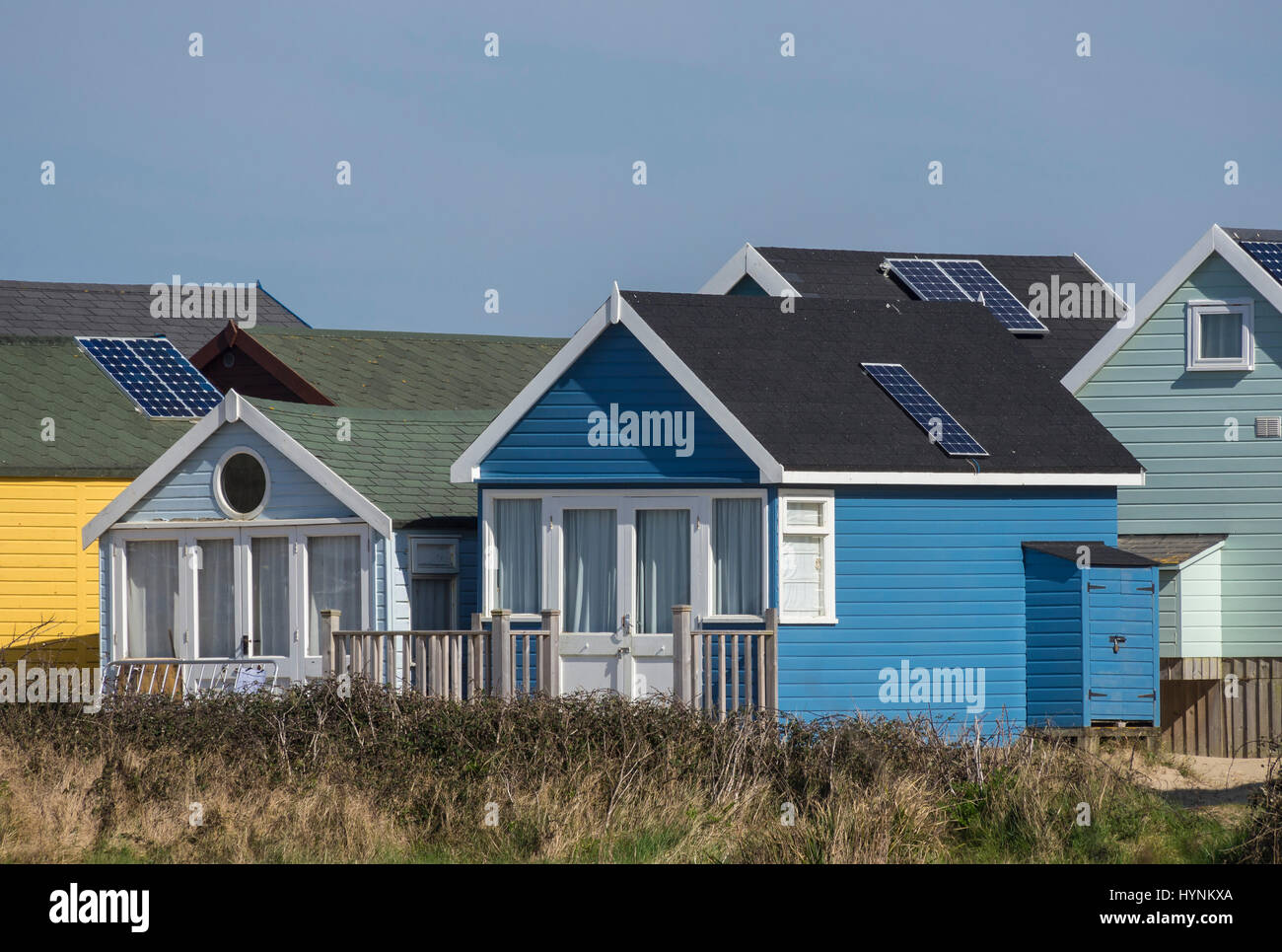 Colorate, costose cabine sulla spiaggia, a Mudeford spiedo o Sandbank a Christchurch Harbour, Dorset, Regno Unito Foto Stock