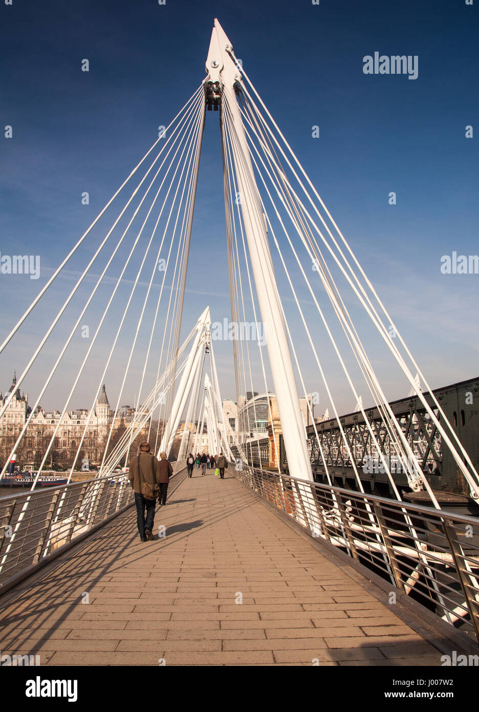 London, England, Regno Unito - 18 Marzo 2009: pedoni attraversare il fiume Tamigi sul Giubileo passerella a Charing Cross a Londra su una mattina di sole. Foto Stock
