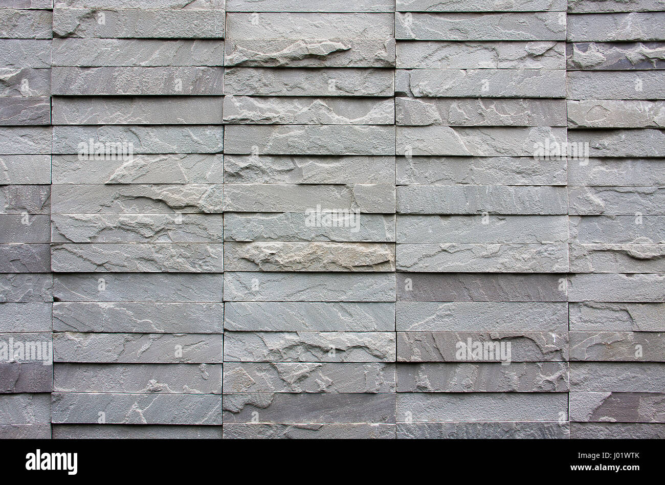 La texture muro di mattoni grigio pietra per lo sfondo Foto Stock