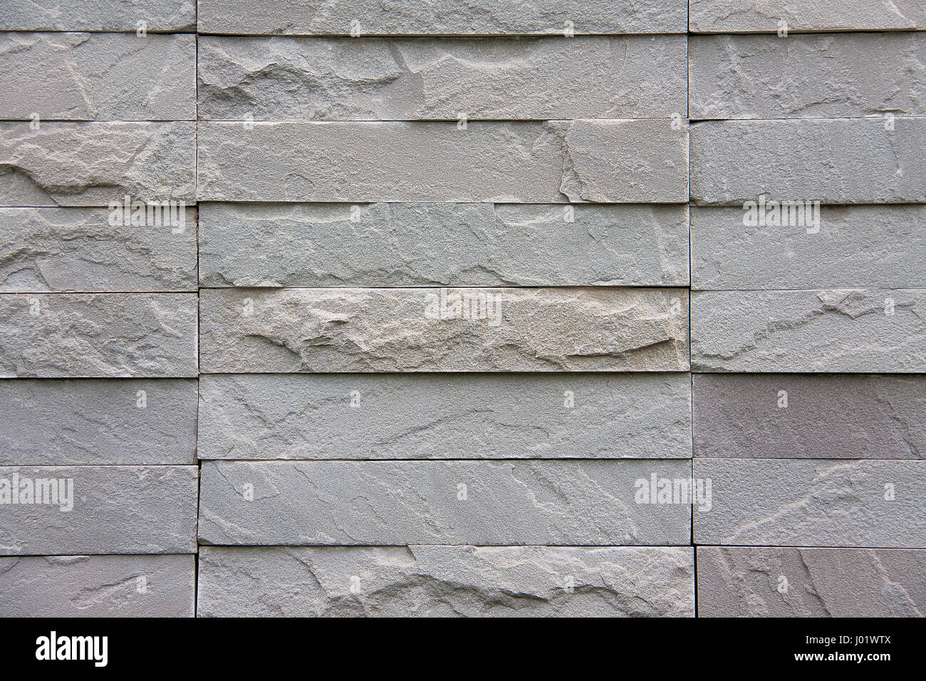 La texture muro di mattoni grigio pietra per lo sfondo Foto Stock