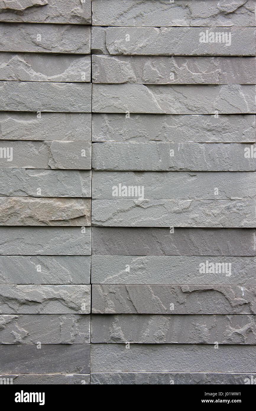 La texture muro di mattoni grigio pietra per lo sfondo Foto Stock