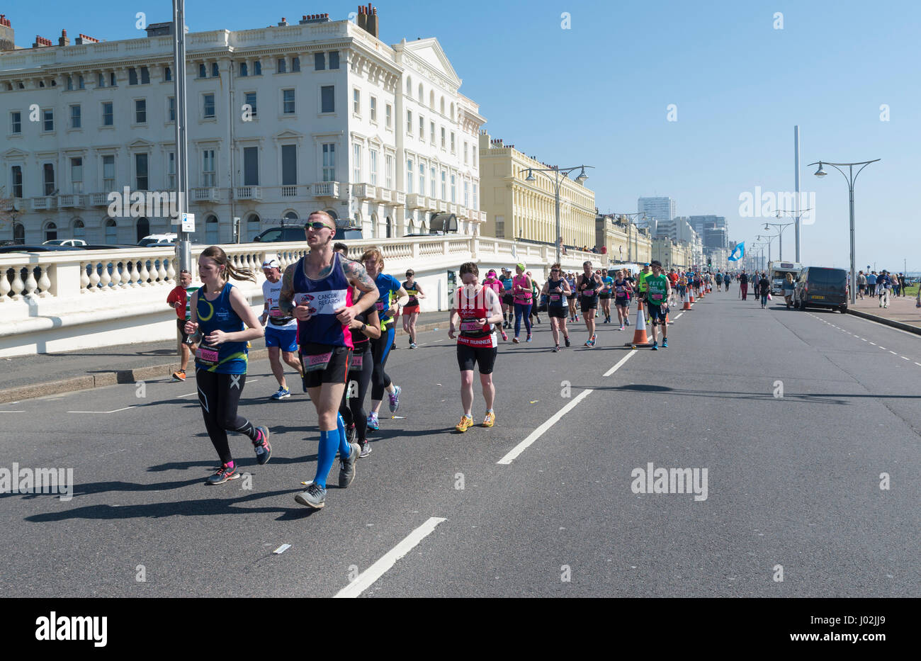 Brighton, Regno Unito. 9 apr, 2017. I corridori gestisce ancora un sorriso pur essendo oltre a metà strada attraverso. Migliaia di persone braved il calore su il giorno più caldo dell'anno finora per partecipare alla maratona di Brighton. Credito: Elizabeth riattivazione/Alamy Live News Foto Stock