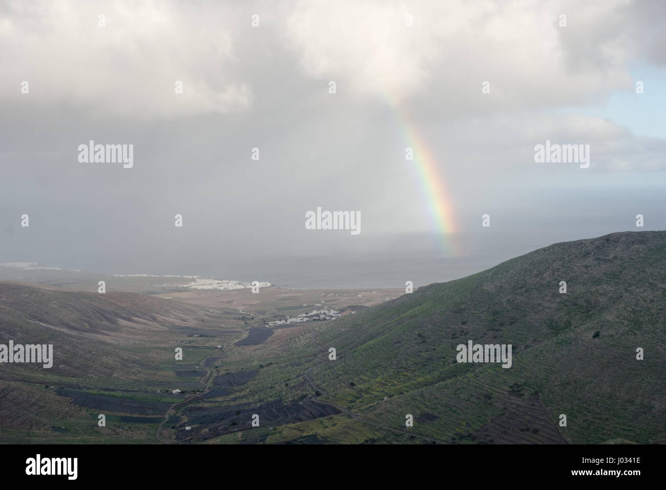 Un arcobaleno si affaccia La-Caleta nel lato nord di Lanzarote, Isole Canarie. Foto Stock