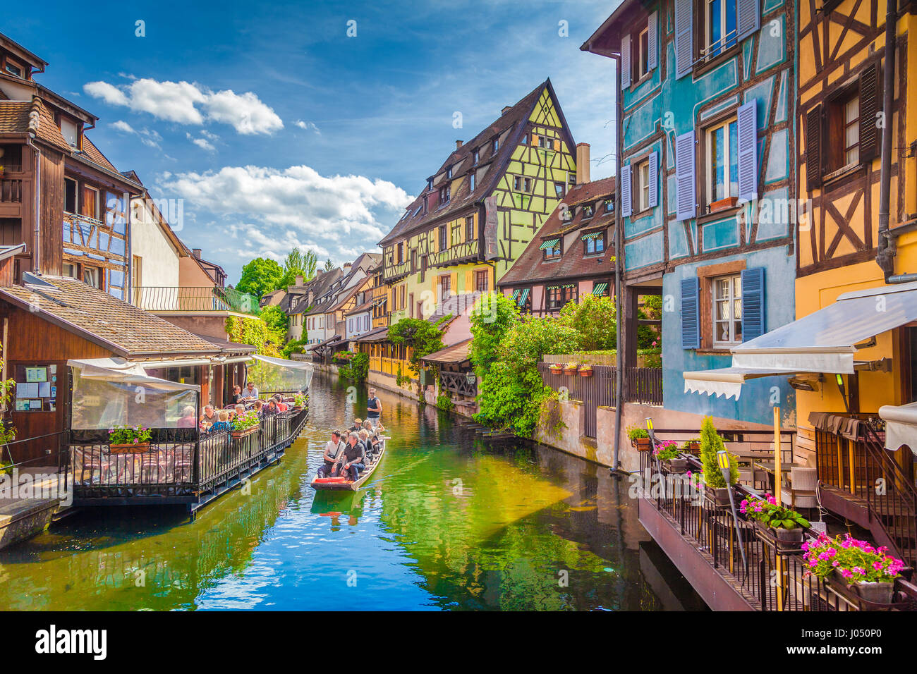 Bellissima vista del centro storico di Colmar, noto anche come piccola Venezia, con turisti facendo un giro in barca lungo il case colorate, Alsazia, Francia Foto Stock