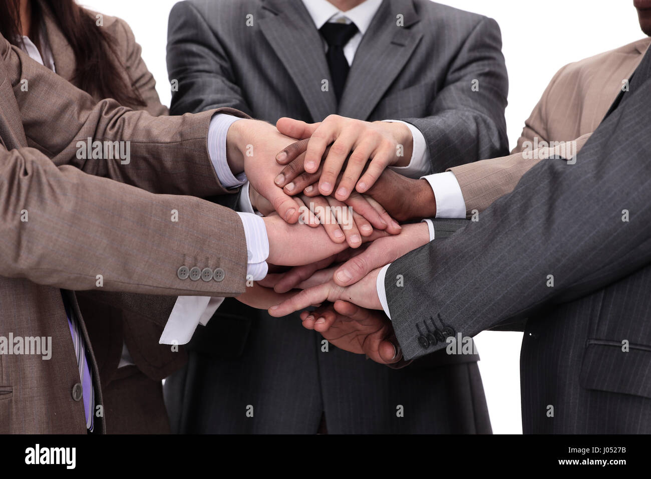 Un gruppo di persone di affari di mettere le mani sulla parte superiore di ogni altri Foto Stock